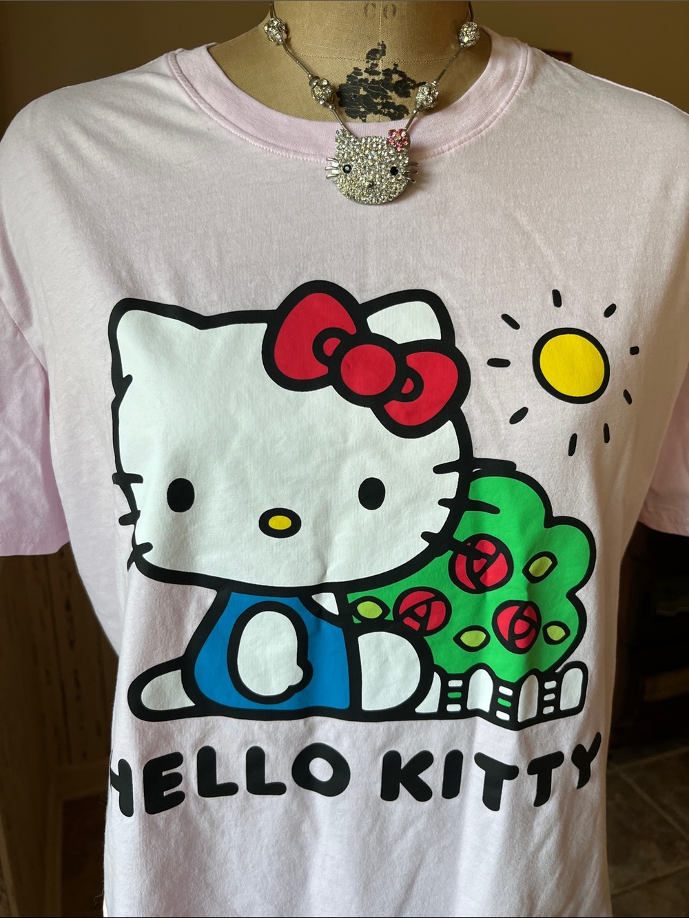 Hello Kitty Light Pink Graphic Tee with Red Bow and Multicolor Print